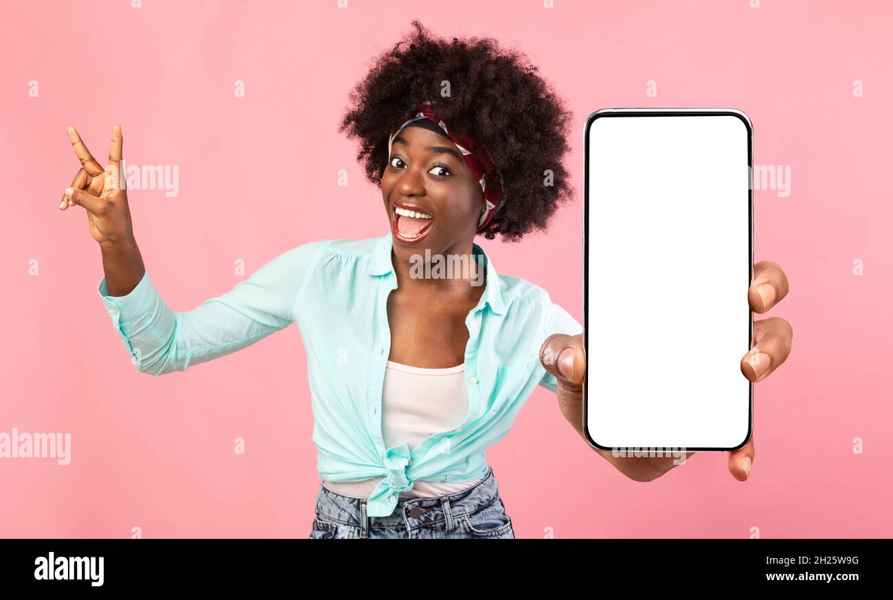 Emotional black woman demonstrating smartphone with empty screen Stock ...