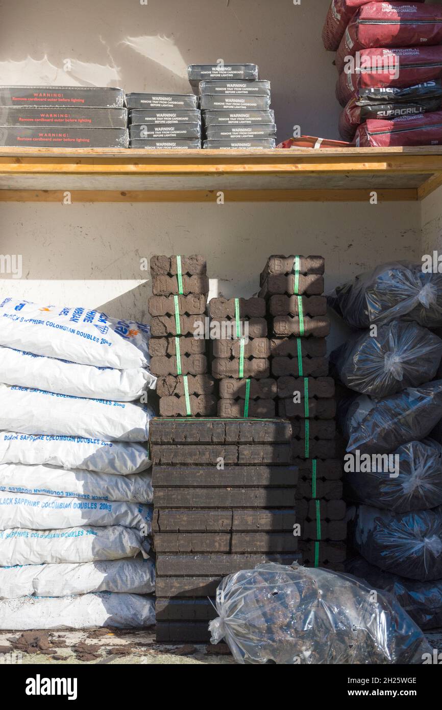 Fossil fuels, turf, peat, coal and peat  briquettes on sale in Ardara, County Donegal, Ireland. Stock Photo