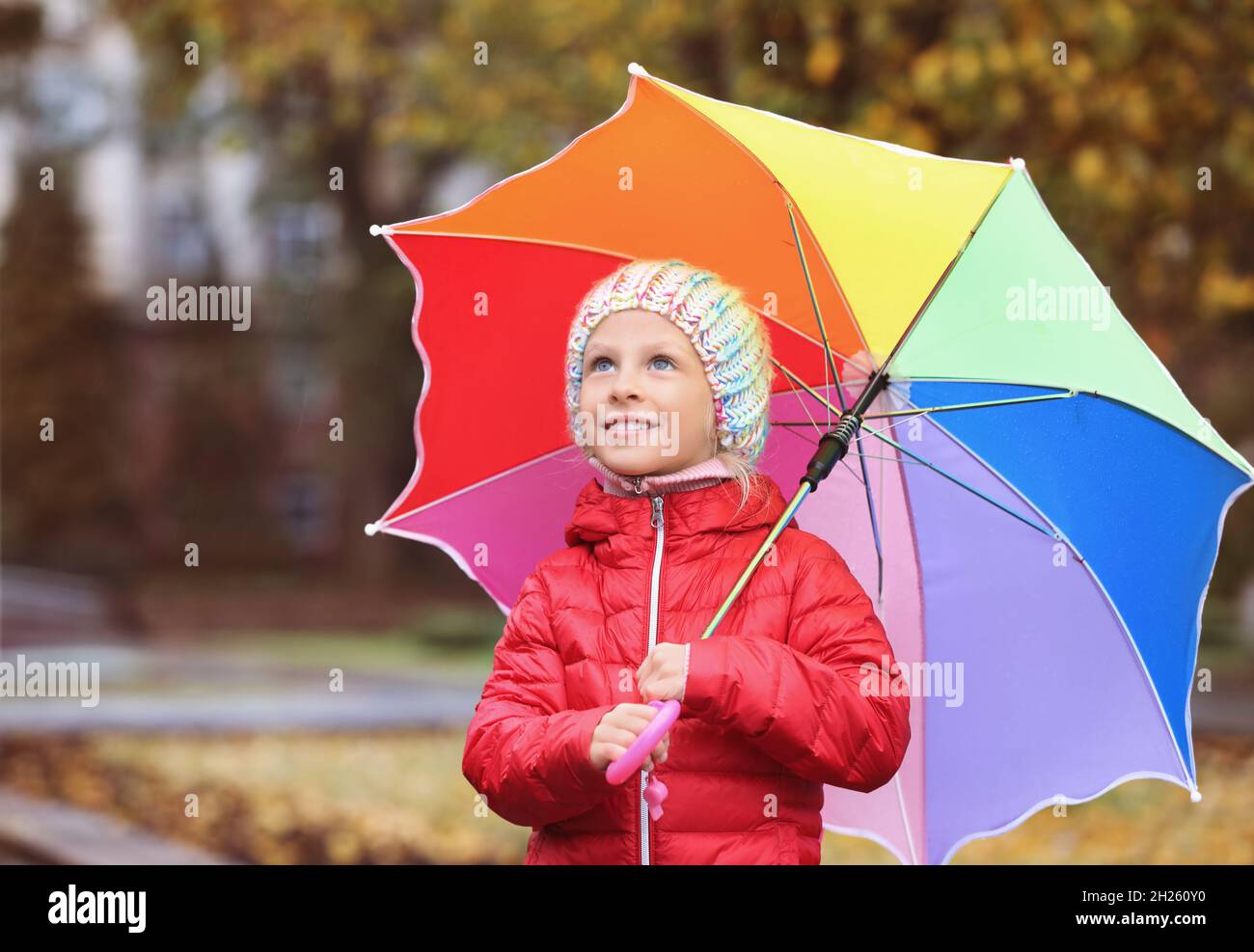 Little girl with umbrella in autumn park on rainy day Stock Photo - Alamy