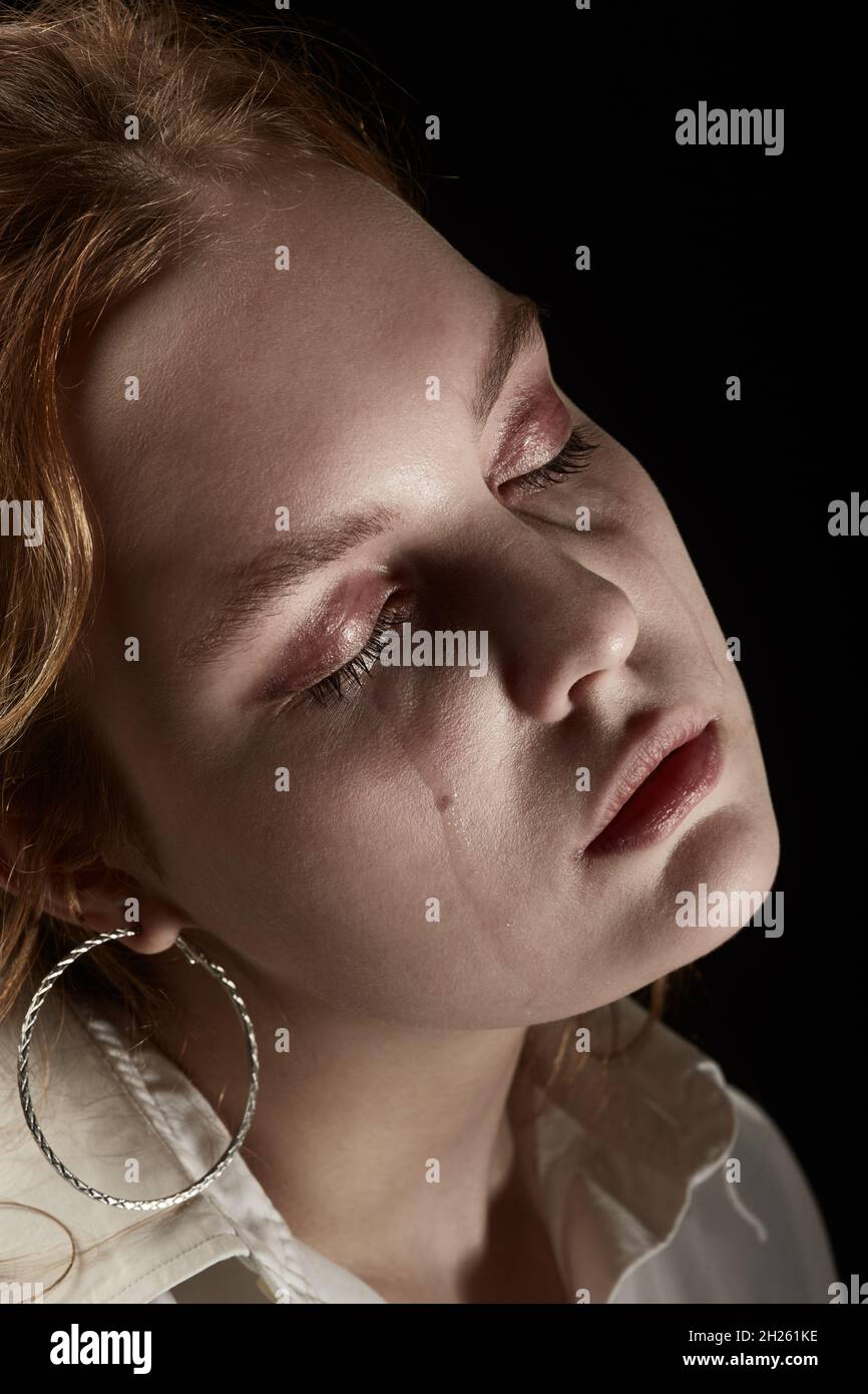 sad woman crying, looking aside on black background, closeup portrait,  profile view Stock Photo - Alamy