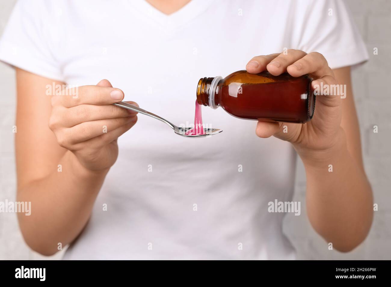 Woman pouring cough syrup into spoon, closeup Stock Photo Alamy