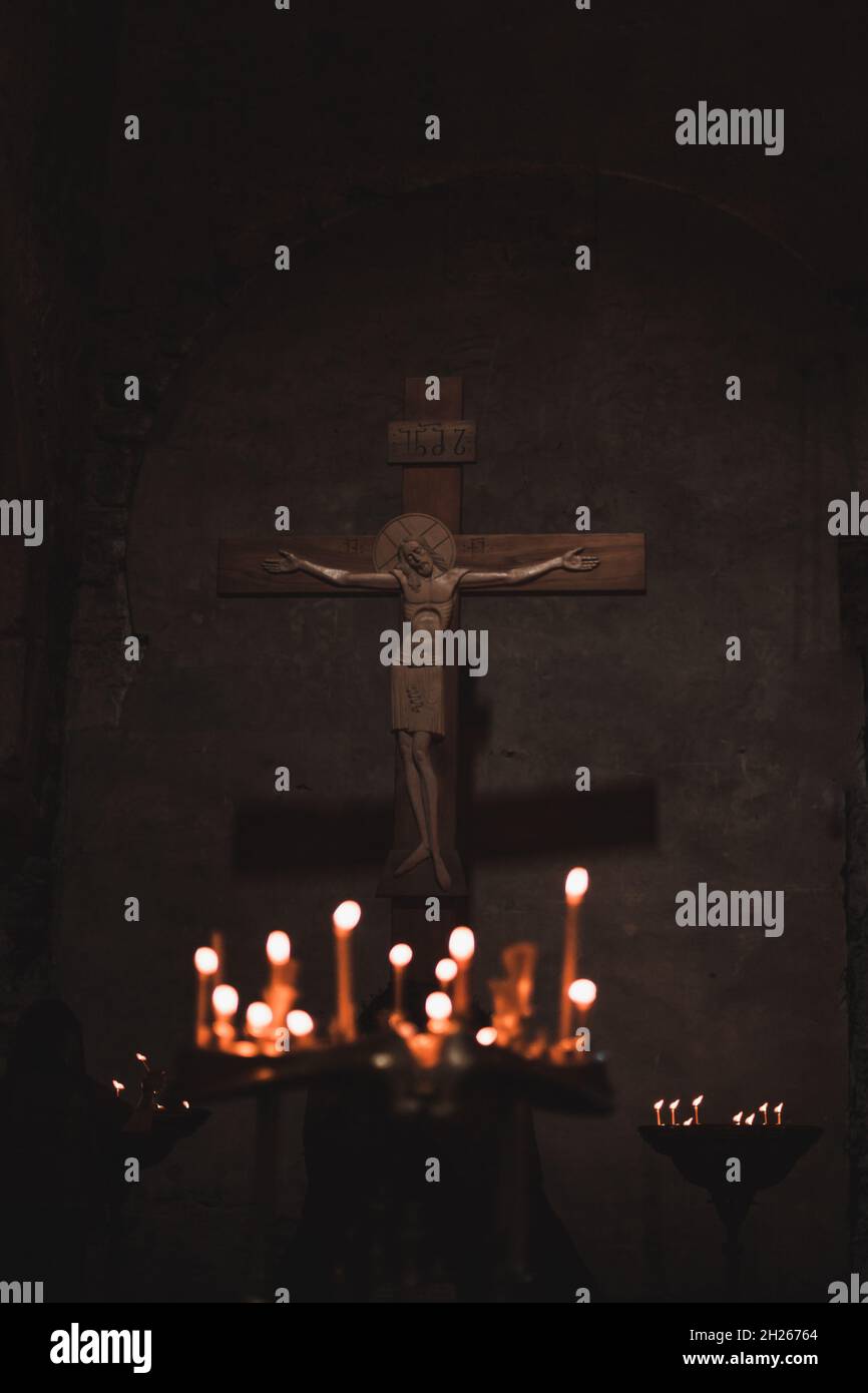 Interior of an ancient Christian cathedral in Georgia. Old orthodox cathedral inside. Antique cross in church and candlestick with wax candles. Stock Photo