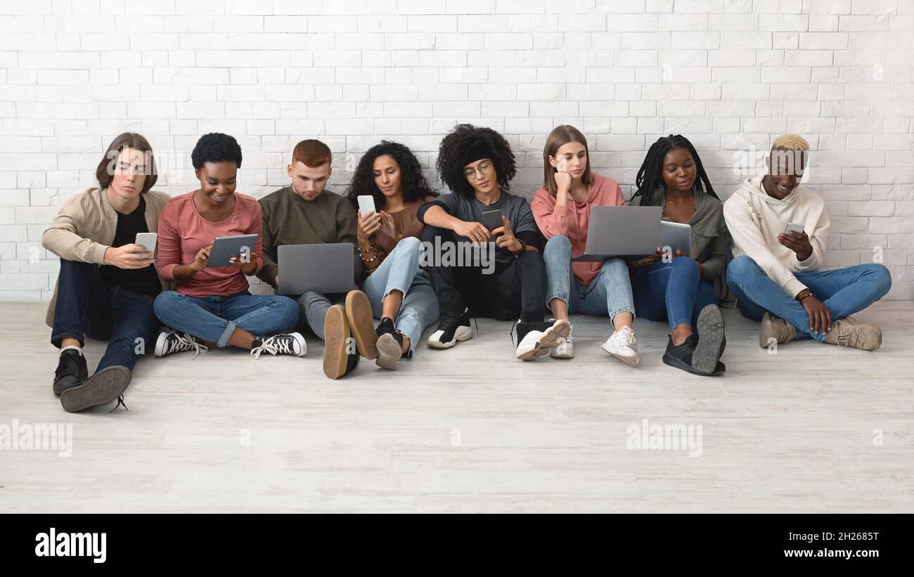 International group of young people using different gadgets Stock Photo