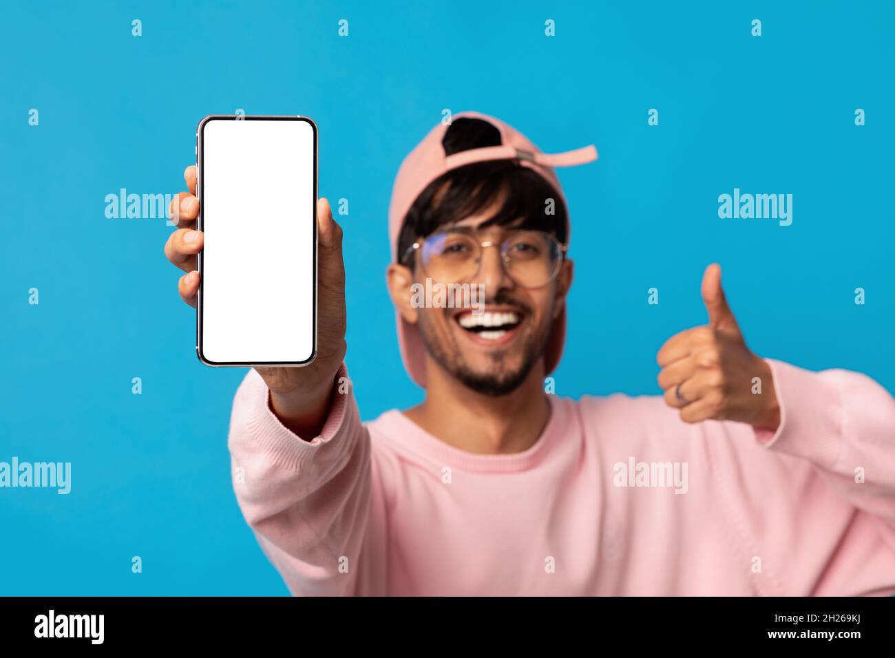 Smartphone with blank screen in young arabic man hand Stock Photo