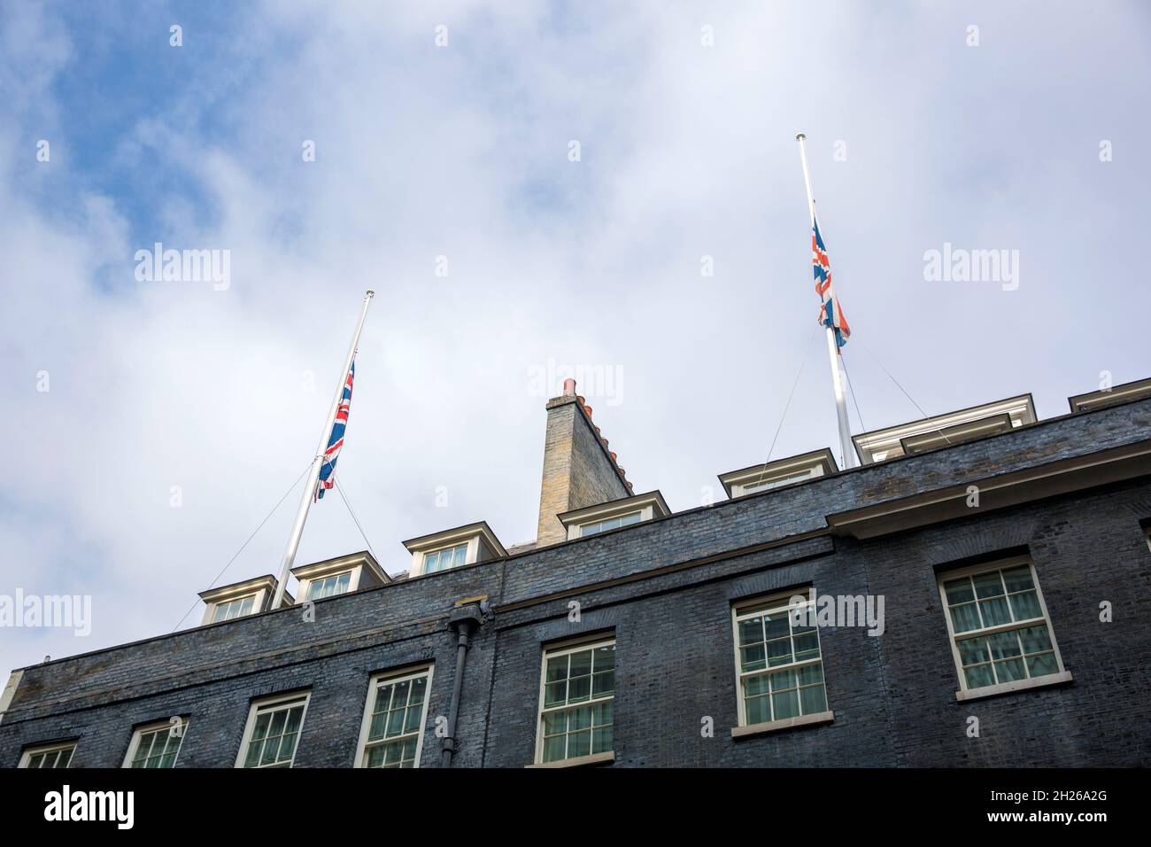 Union Flags fly at halfmast on the top of the building that houses 10