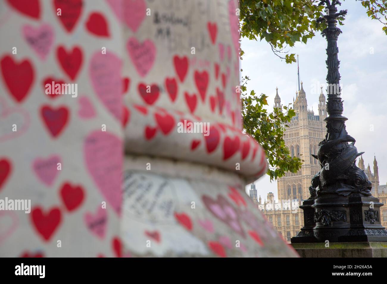 The Palace of Westminster, the Houses of Parliament, is seen behind the National Covid Memorial Wall, in central London, Saturday, 16 October 2021. Stock Photo