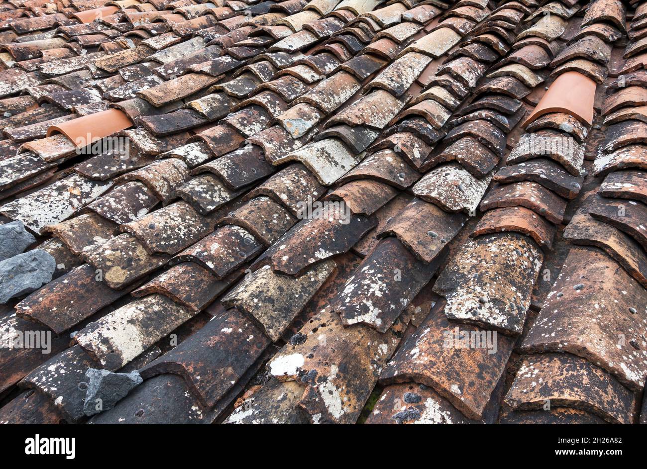 Old weathered ceramic tiled roof Stock Photo