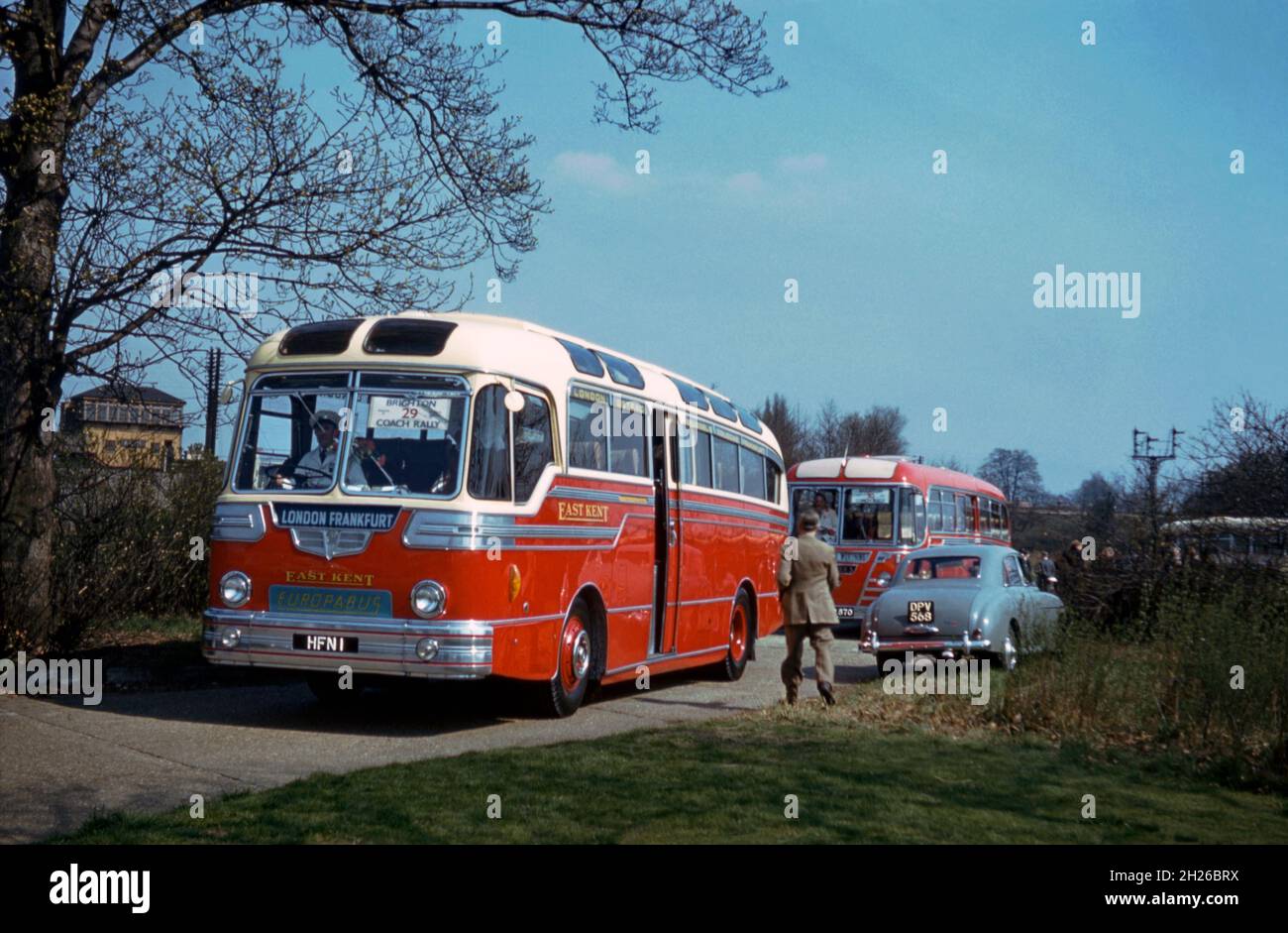 A coach of The East Kent Road Car Company on its way to a bus rally in Brighton, East Sussex, England, UK in 1956. The vehicle is a Duple bodied Leyland Royal Tiger registered HFN 1. The destination boards indicate that the coach was used on the company’s continental routes to Frankfurt, Germany that began in the 1950s. A ‘Europabus’ plate is visible on the front. The company operated ‘Europabus’ connections between London and Dover Dock for onward coach travel from Ostend. The East Kent Road Car Company Ltd formed in 1916 and based in Canterbury, Kent – a vintage 1950s photograph. Stock Photo