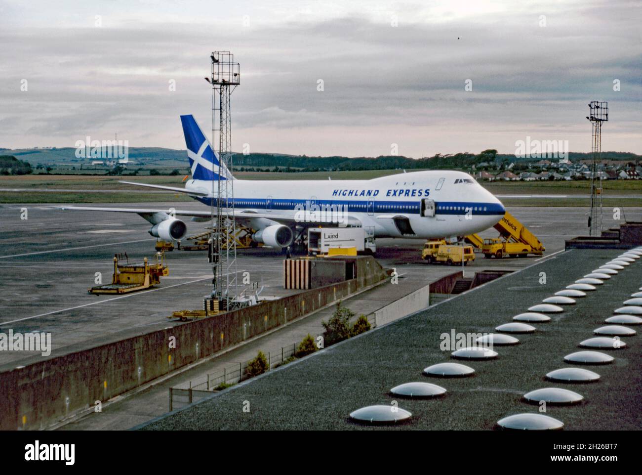 A Highland Express Boeing 747 at Prestwick Airport, Glasgow, Scotland, UK in 1987. The airline was formed by Randolph Fields. The Highland Express fleet consisted of just one aircraft, which was Boeing 747-100. The transatlantic service began in 1987 and consisted of flights from Stansted or Birmingham to Newark, New York via Prestwick. Highland Express was the first scheduled low-cost carrier from Prestwick, Stansted and Birmingham. However, passenger numbers did not materialise. Debts mounted and Highland Express ceased operations later that year – a vintage 1980s photograph. Stock Photo