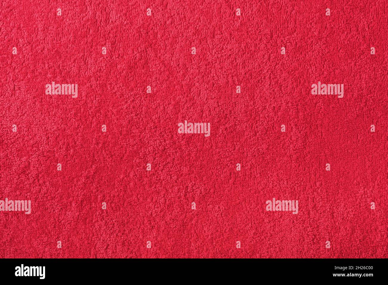 Red towel cloth texture. Background from a terry fabric. Top view with copy space and mockup. Stock Photo