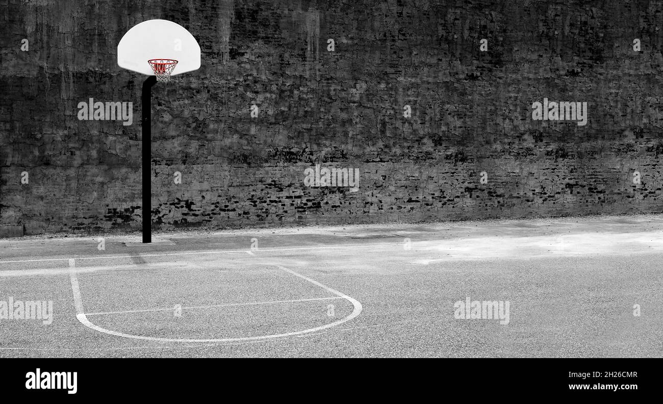 Detail of urban basketball hoop inner city innercity wall and asphalt in outdoor park grunge brick Stock Photo