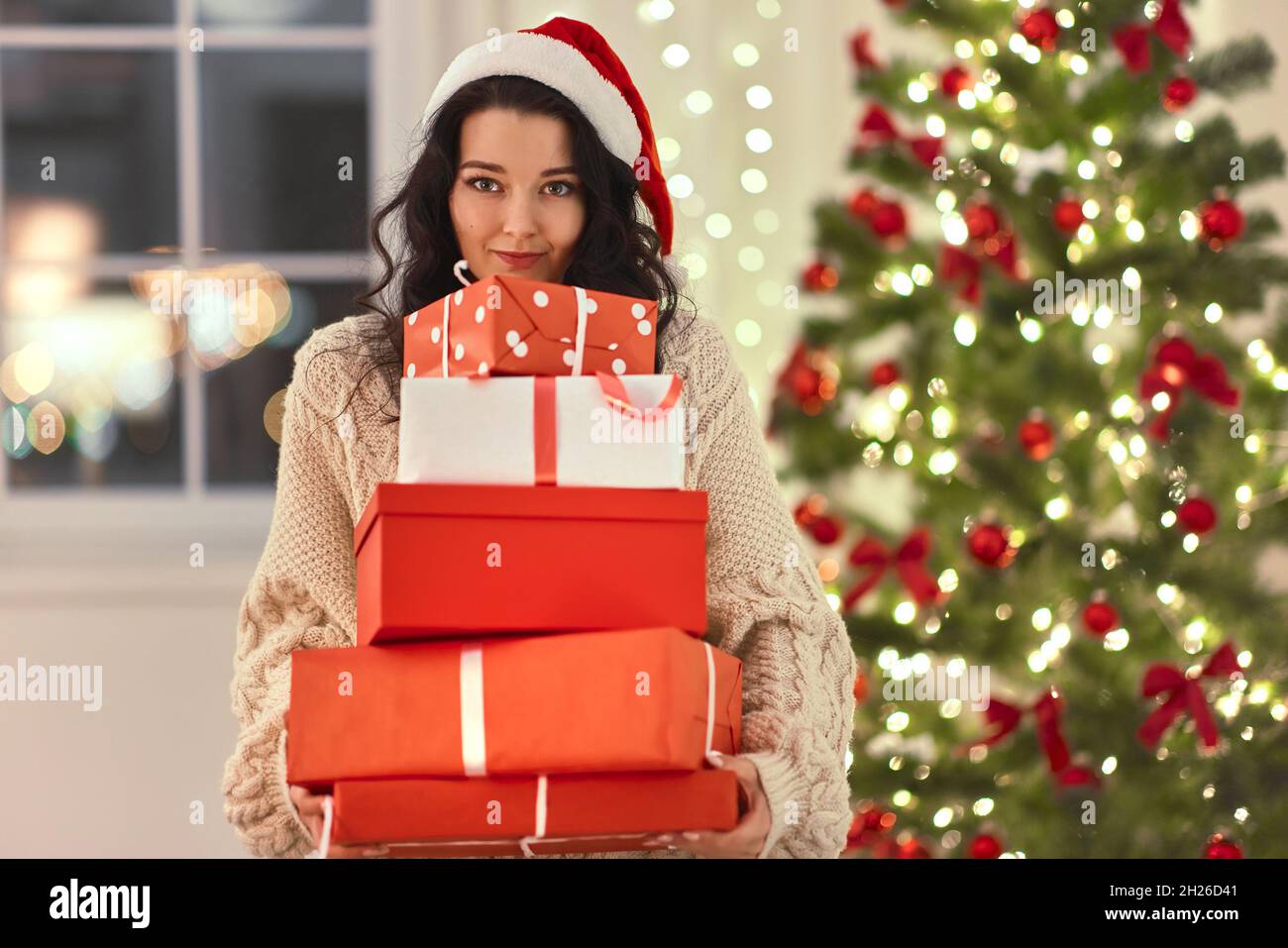 Funny Christmas Santa Woman With Gifts at Home Stock Photo - Alamy