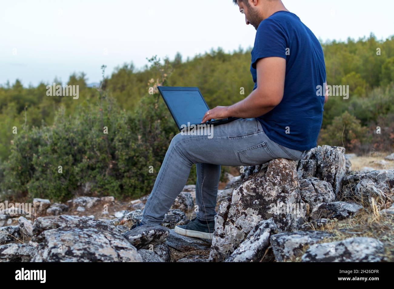 man working online in the jungle. Stock Photo