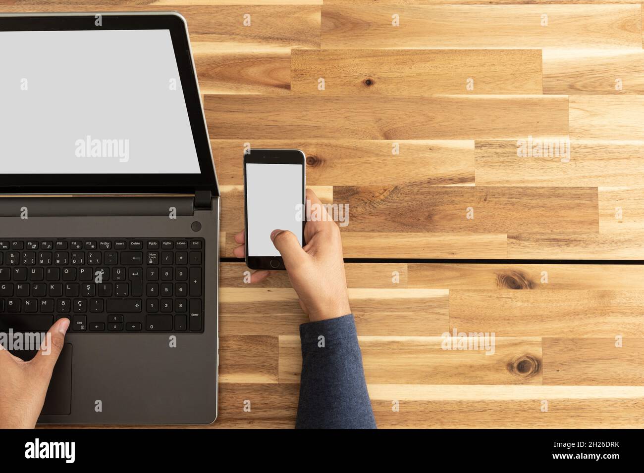 Man using laptop and smartphone. Screen mockup Stock Photo
