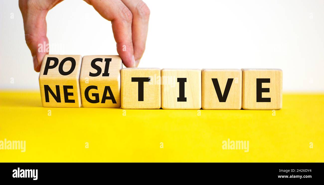 Positive or negative symbol. Businessman turns wooden cubes and changes ...