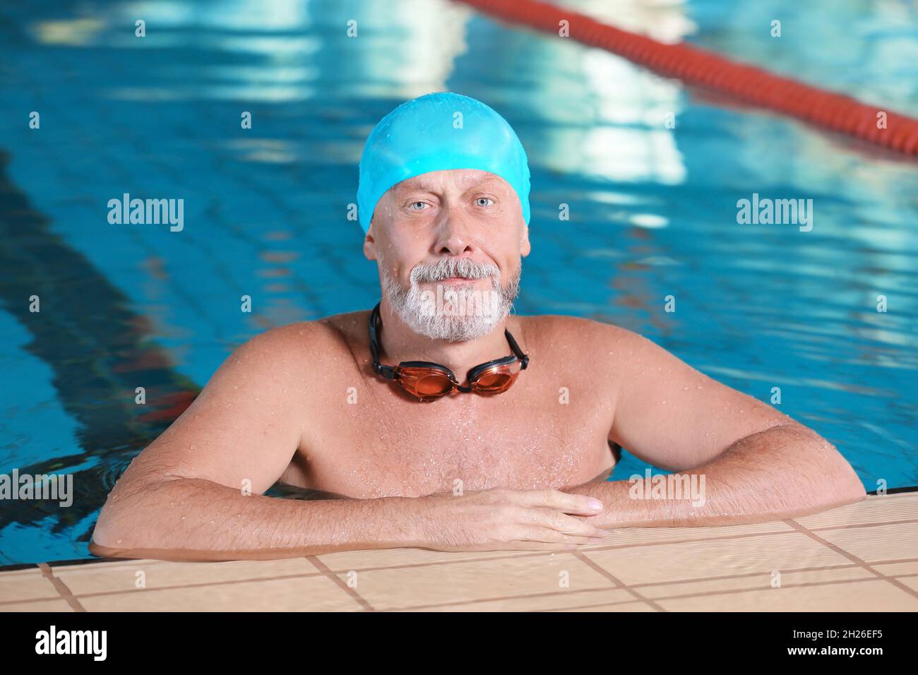 Sportive senior man in indoor swimming pool Stock Photo Alamy