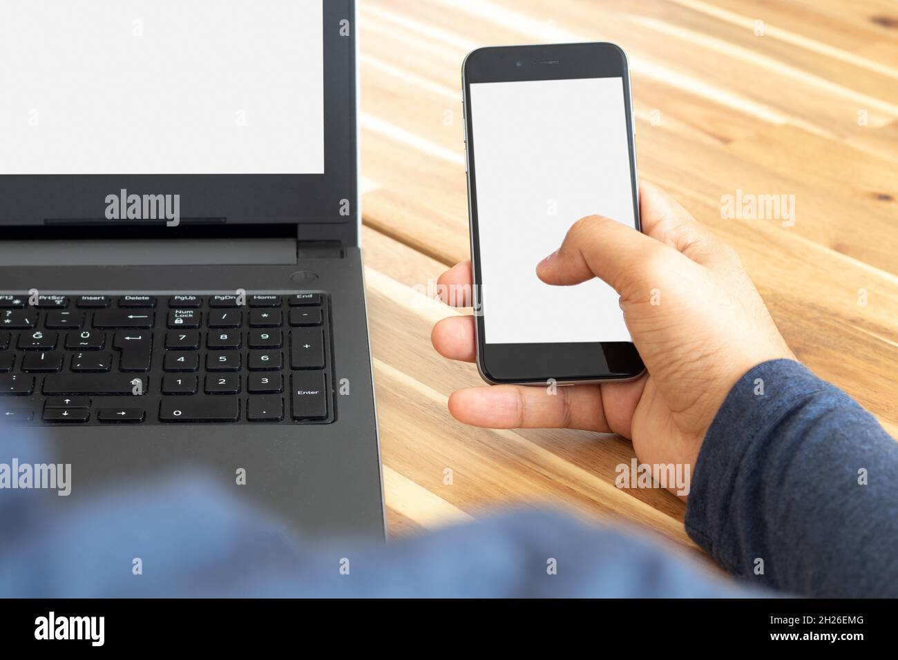 Man using laptop and smartphone. Screen mockup Stock Photo