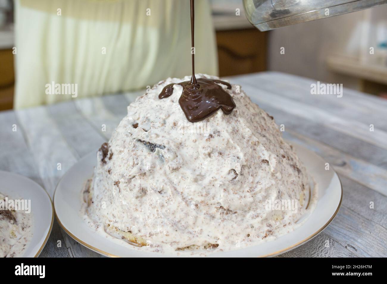 A step-by-step process for making a sour cream chocolate cake. The formed cake is poured with liquid chocolate icing. Stock Photo