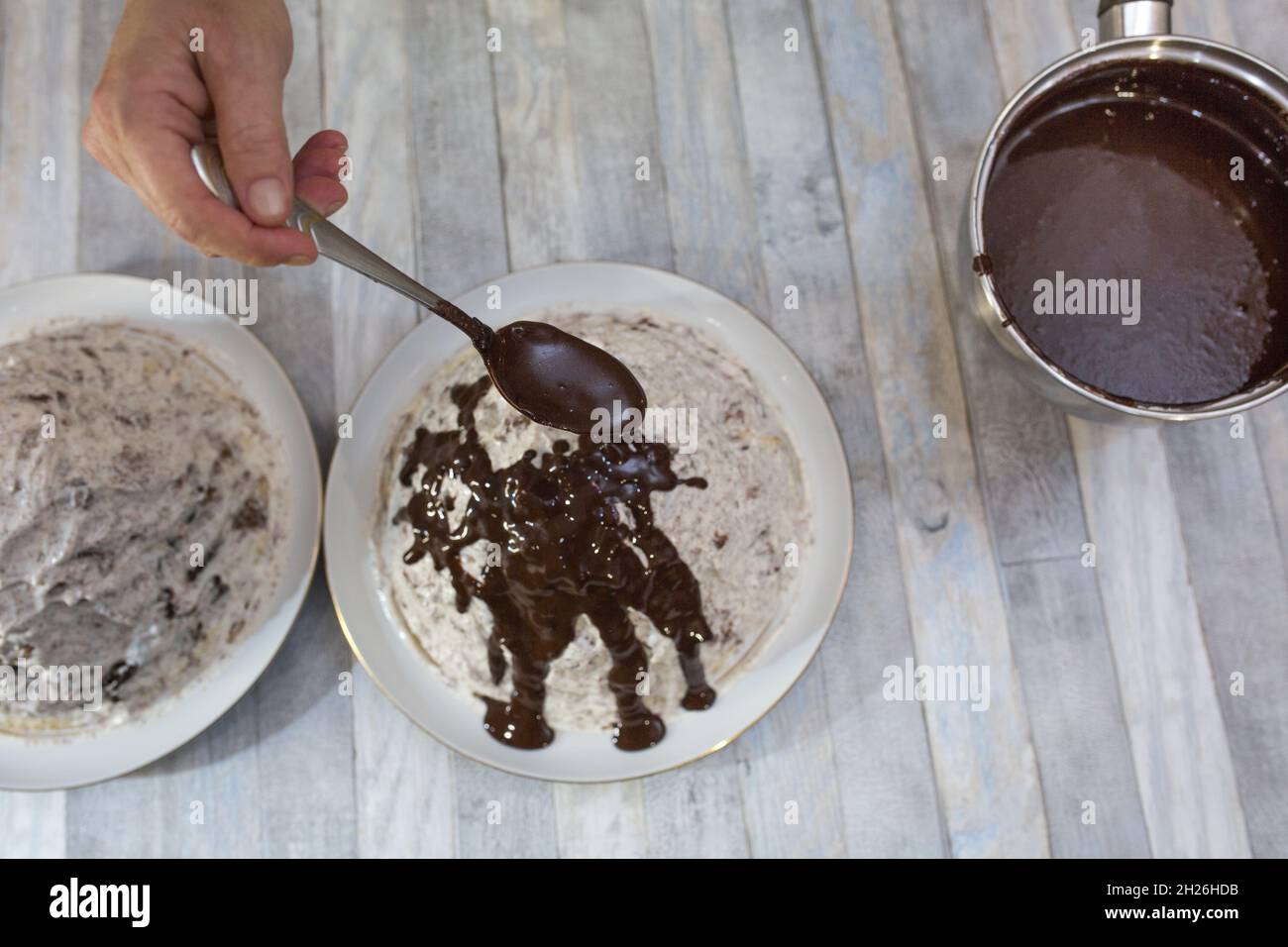 A step-by-step process for making a sour cream chocolate cake. The formed cake is poured with liquid chocolate icing. Stock Photo