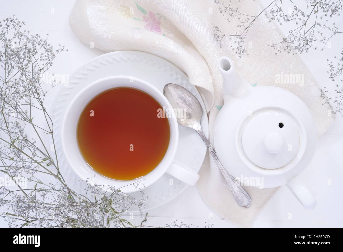 Top down view of a cup of tea and a teapot. Stock Photo