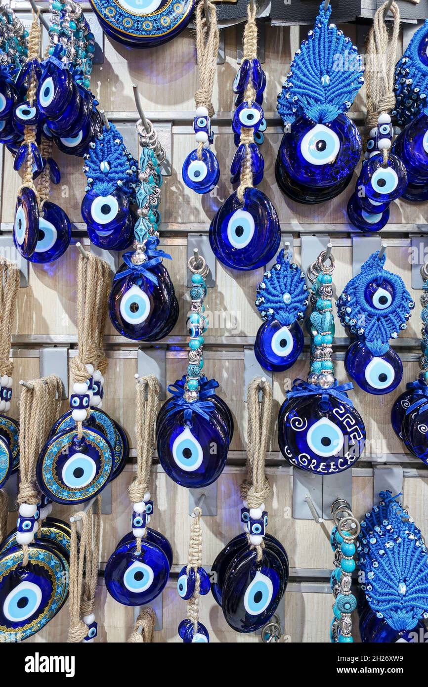 Evil eye keepsake souvenirs hung on a rack in a Greek store for sale Stock Photo