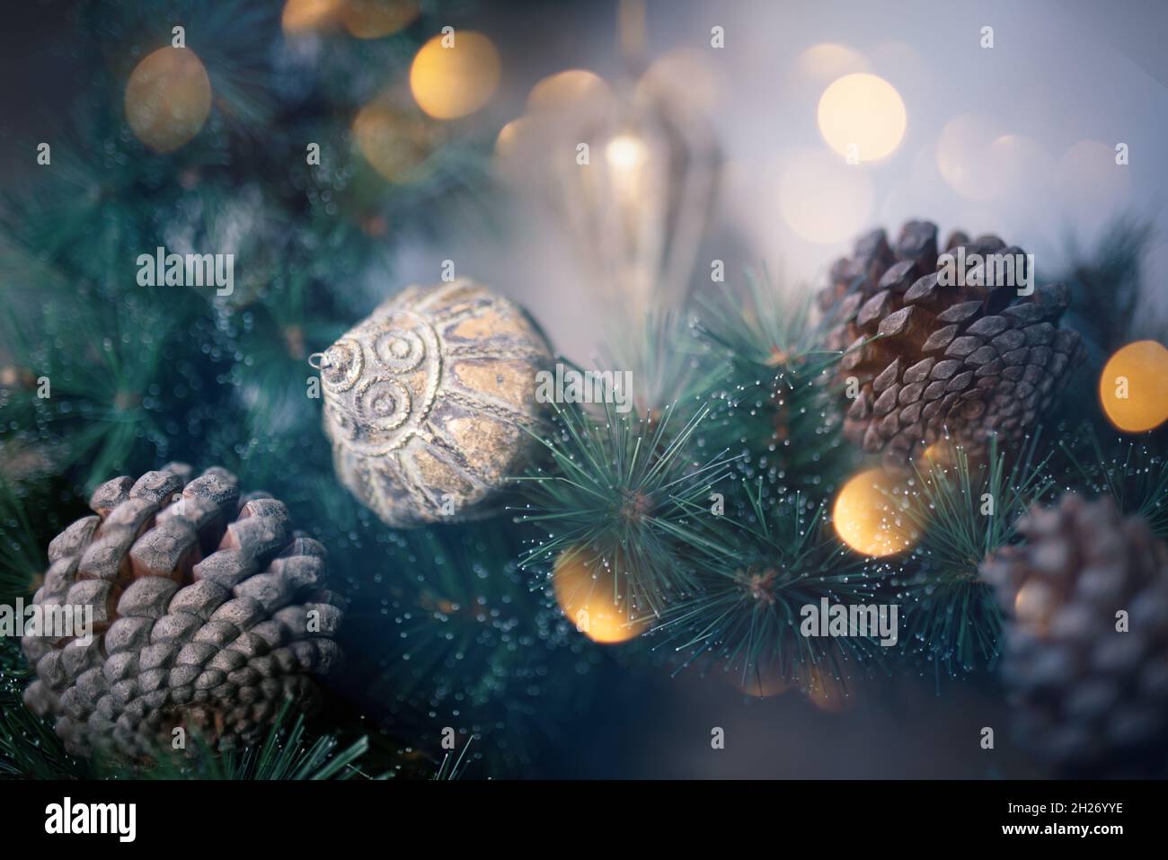 Various Christmas decorations, pine cones and green fir branches ...