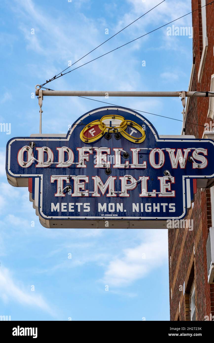A blue sign for the Oddfellows Temple hangs on the side of a brick building in Salem, Illinois, advertising “Meets Mon. nights.” Stock Photo