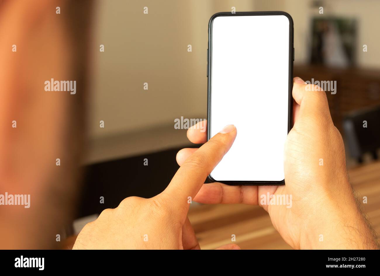 Man using smartphone as a screen mockup. Stock Photo