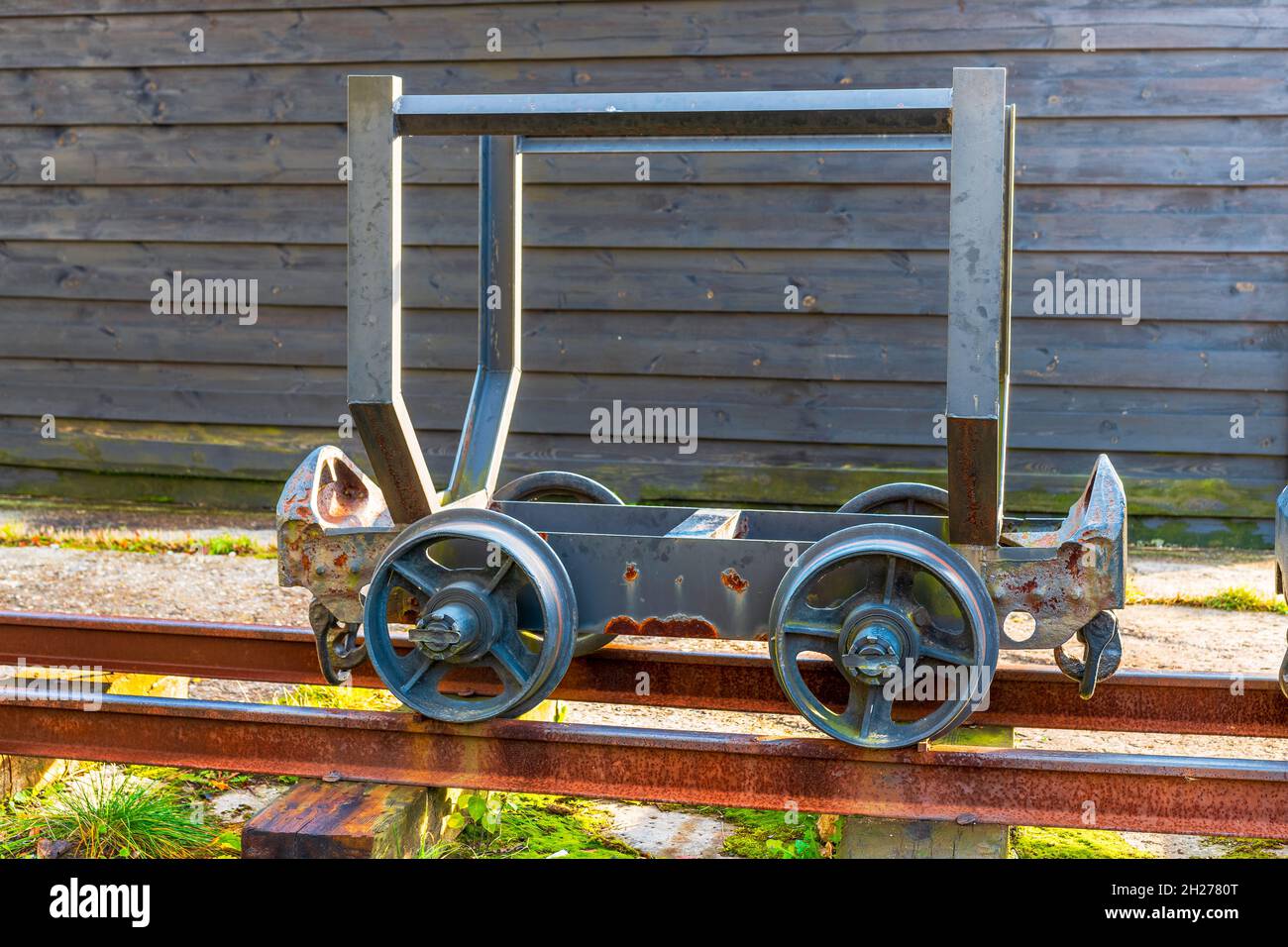 Traditional, old mine cart standing on a steel, railway tracks. Culture center in Siemianowice, Silesia, Poland. Stock Photo