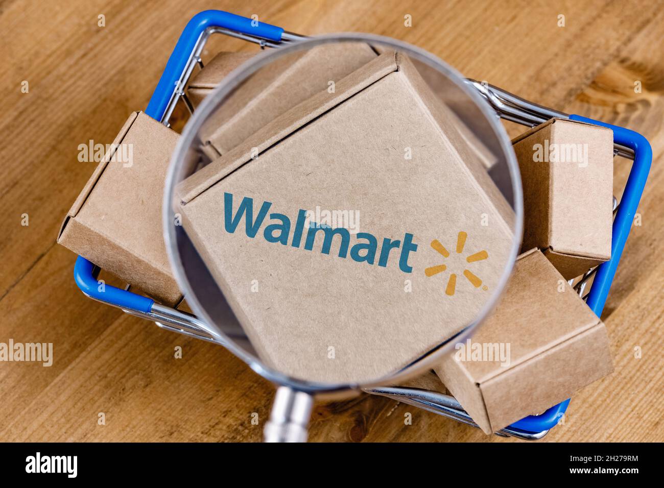 Walmart is an American multinational retail corporation. Modified photo of  Walmart logo on a box under magnifying glass in the shopping cart Stock  Photo - Alamy