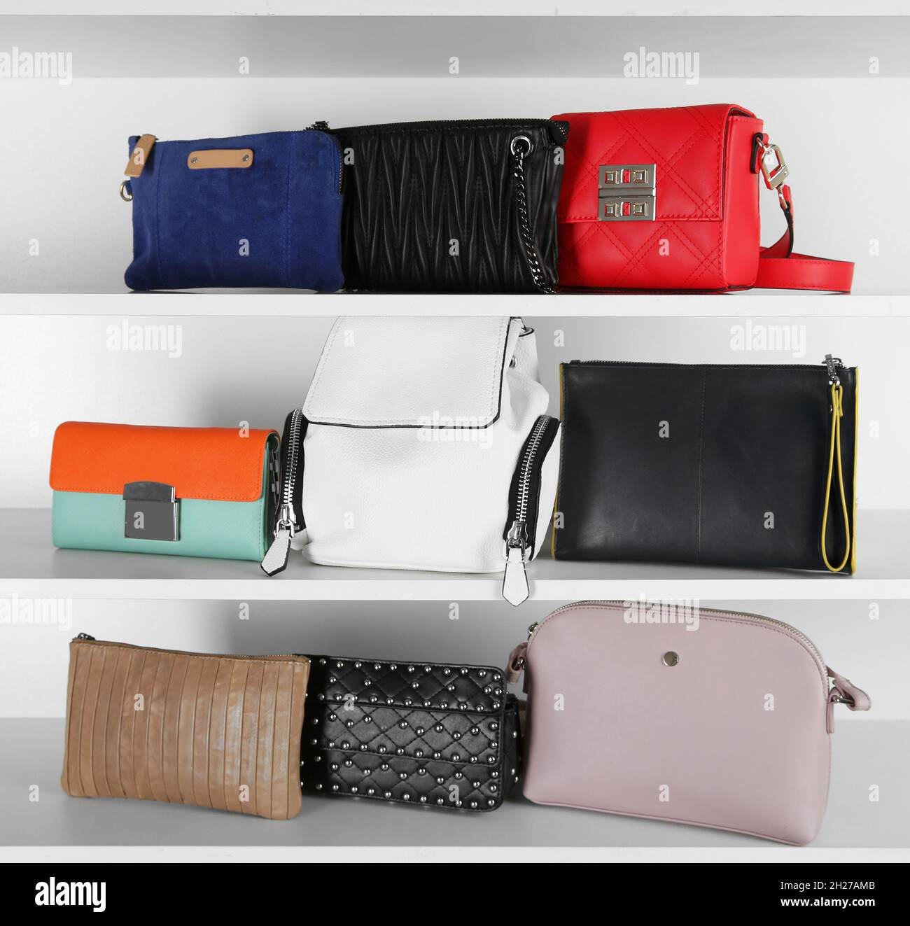 White shelving unit with stylish purses, closeup. Element of dressing