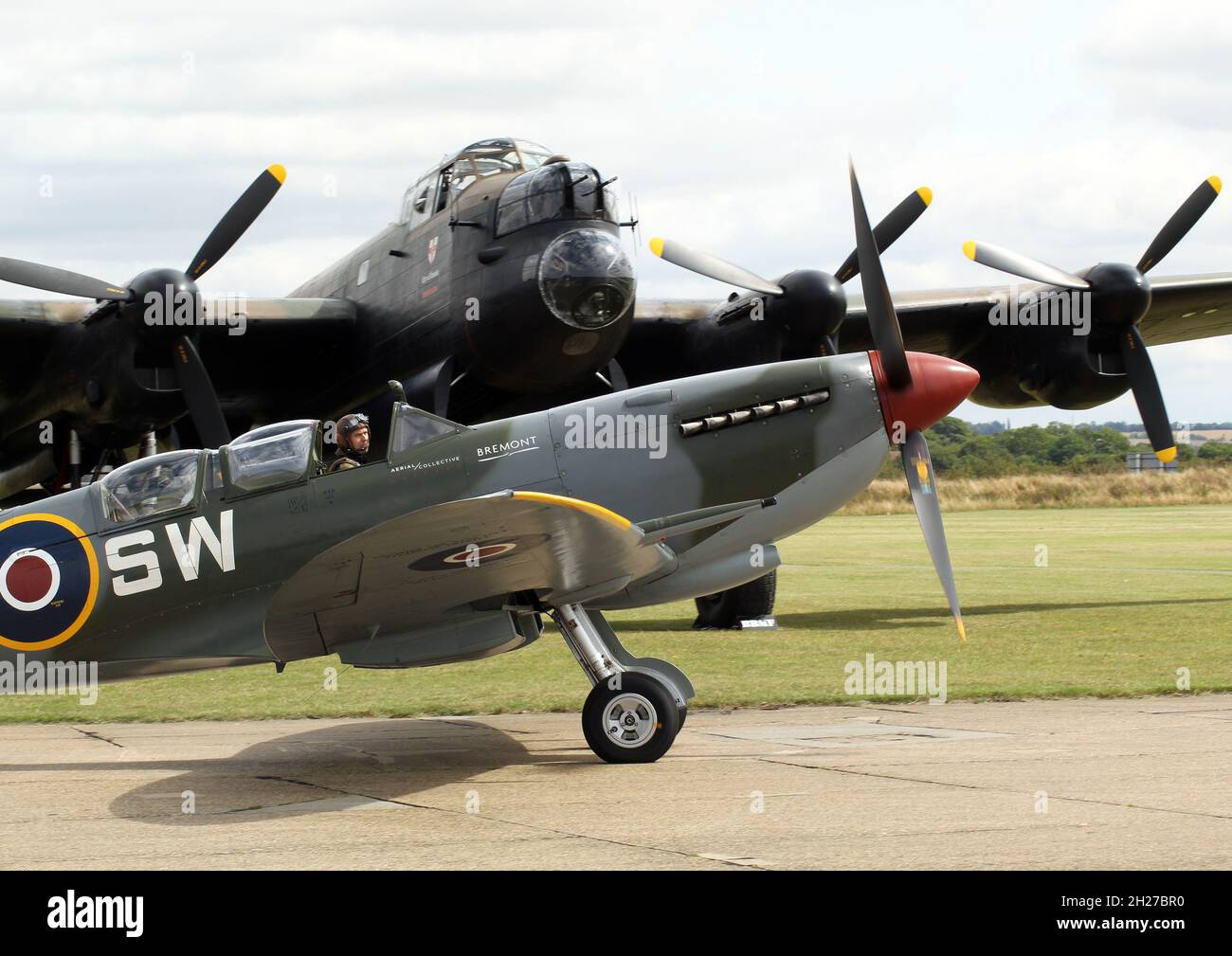 A Supermarine Spitfire and the Battle of Britain memorial flight Lancaster Bomber at IWM Duxford, summer 2022 Stock Photo