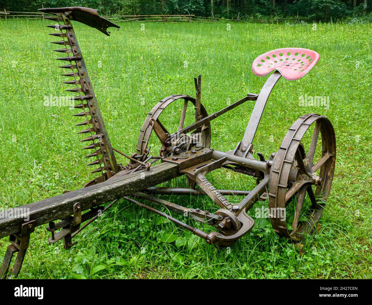 Old sickle bar mower on the grass Stock Photo