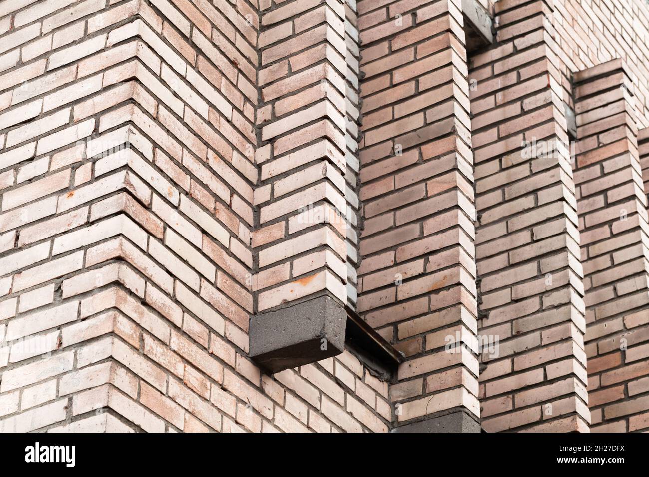 Abstract urban architecture, corner of a brick wall with decoration elements Stock Photo