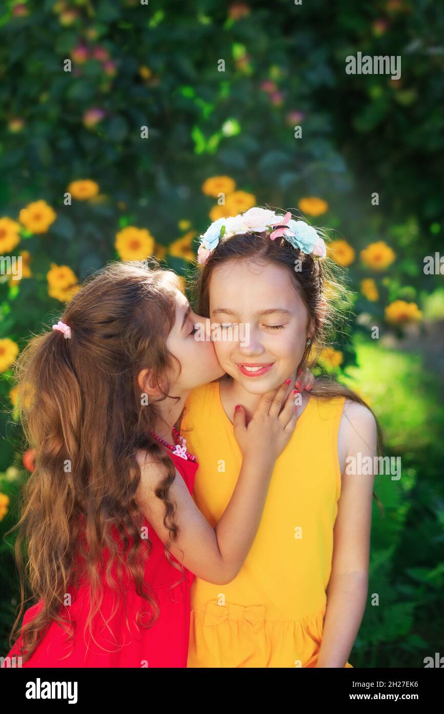 Two Cute little girls embracing and smiling at summer party. Happy kids outdoors. Place for text Stock Photo