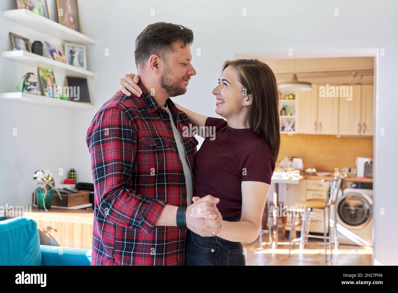 Happy romantic middle aged couple dancing at home Stock Photo