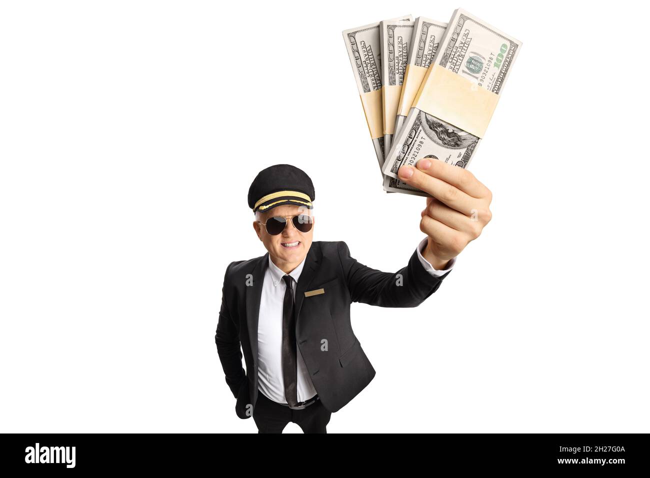 Chauffeur in a uniform holding a stacks of money in front of camera isolated on white background Stock Photo