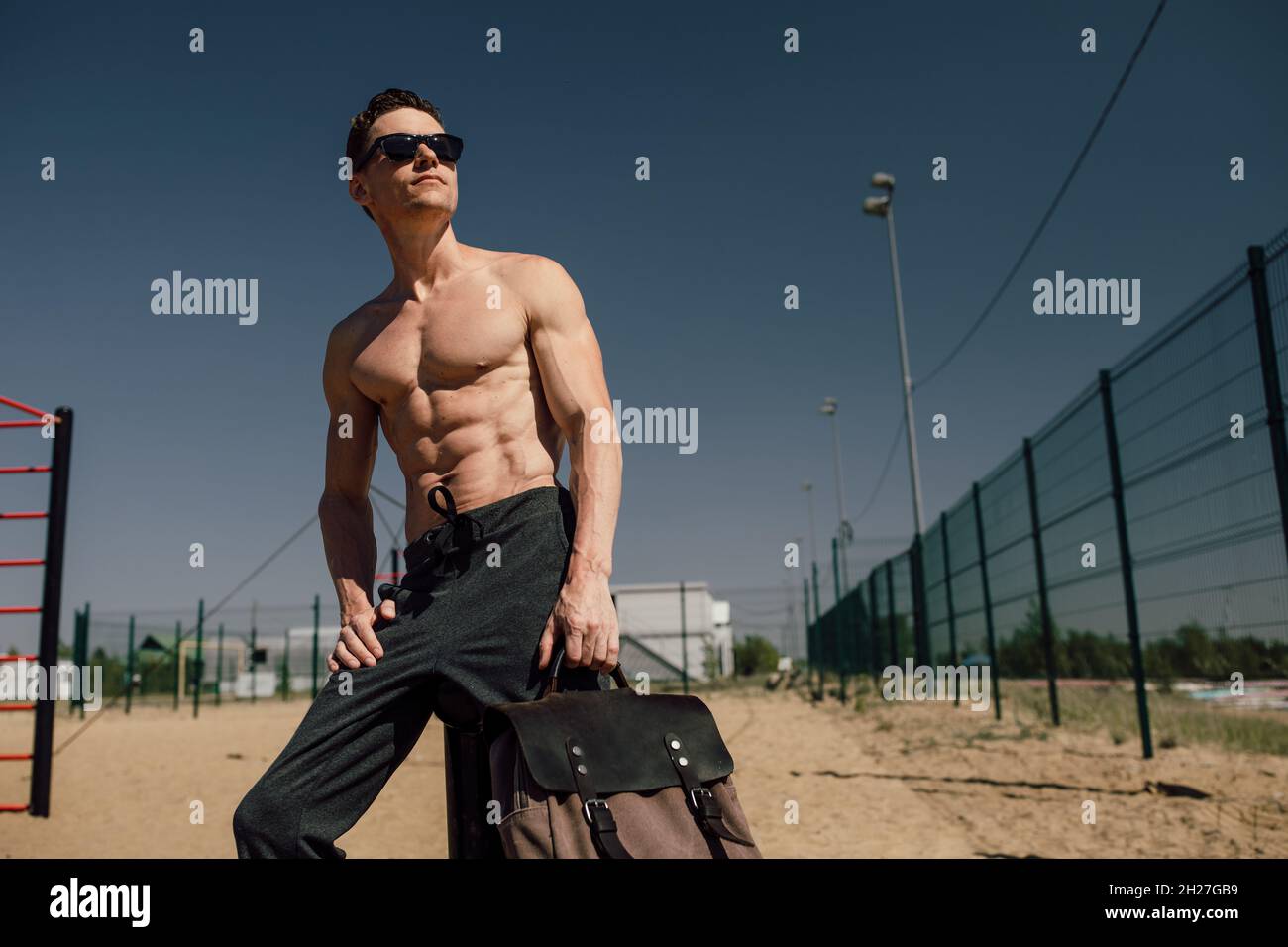 young athlete with a beautiful body posing at the camera. Outdoor training Stock Photo