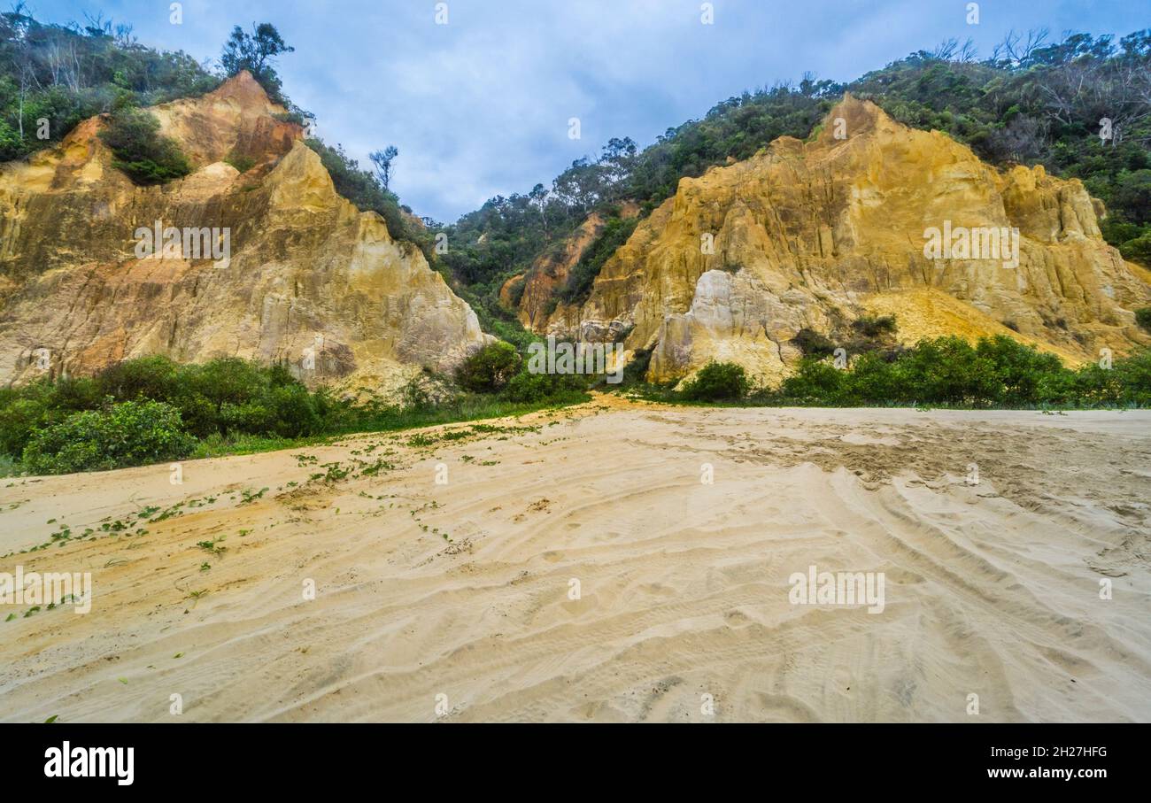 the coloured sand of the eroded sand dune cliffs of Rainbow Beach in the Cooloola Section of the Great Sandy National Park, Gympie Region, Qeensland, Stock Photo