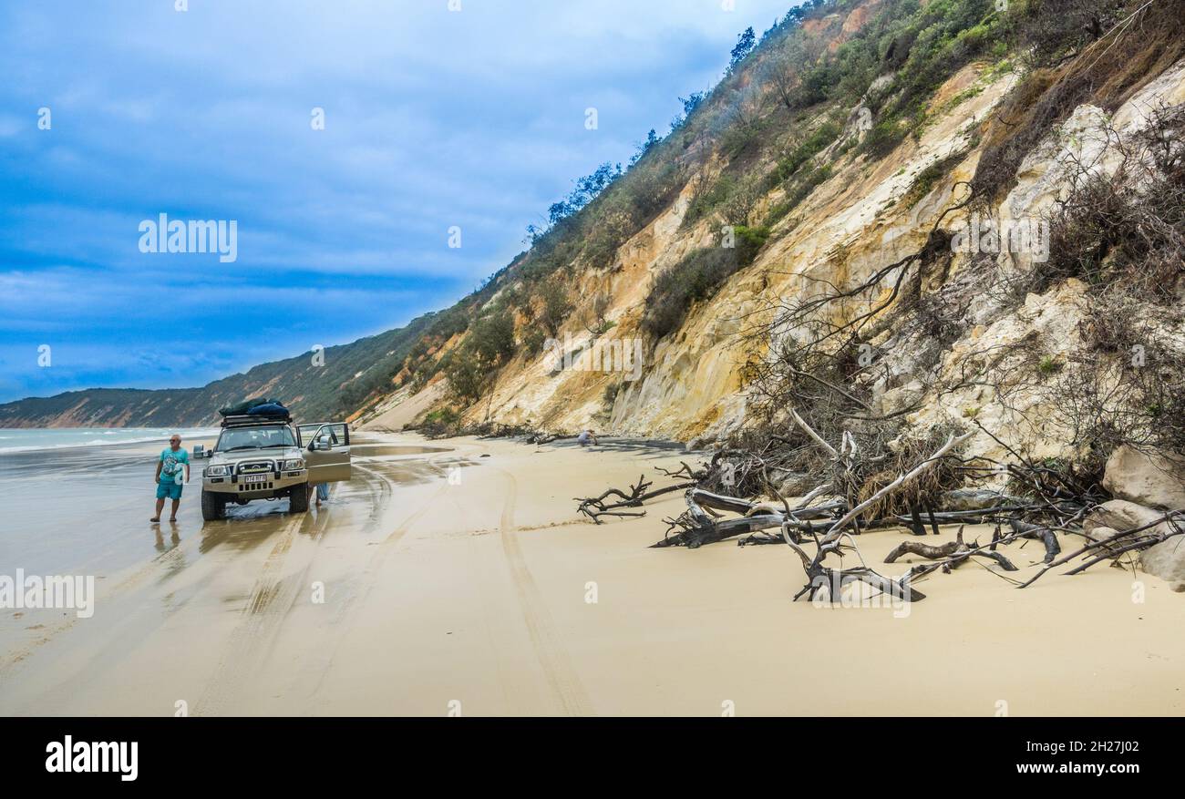 Four-wheel drive travel allong the coloured sand of the eroded sand dune cliffs of Rainbow Beach in the Cooloola Section of the onal Park, Gympie Regi Stock Photo