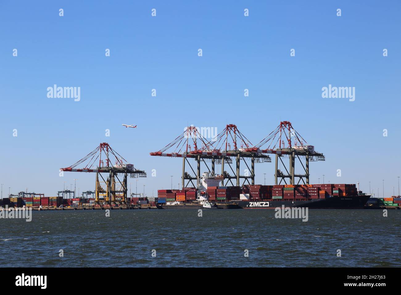 Bayonne, USA. 20th Oct, 2021. Containers are seen in the process of logistics operations at Maher Terminal owned by the Port Authority of New York and New Jersey in Bayonne, New Jersey, the United States, on Oct. 19, 2021. The United States has been plagued by supply chain disruptions in recent months, and the White House has asked the Port of Los Angeles to become a 24-hour port, open seven days a week. However, with the approach of holidays, which will see surging demand across the country, the shipping-based supply chain remains under stress. Credit: Liu Yanan/Xinhua/Alamy Live News Stock Photo