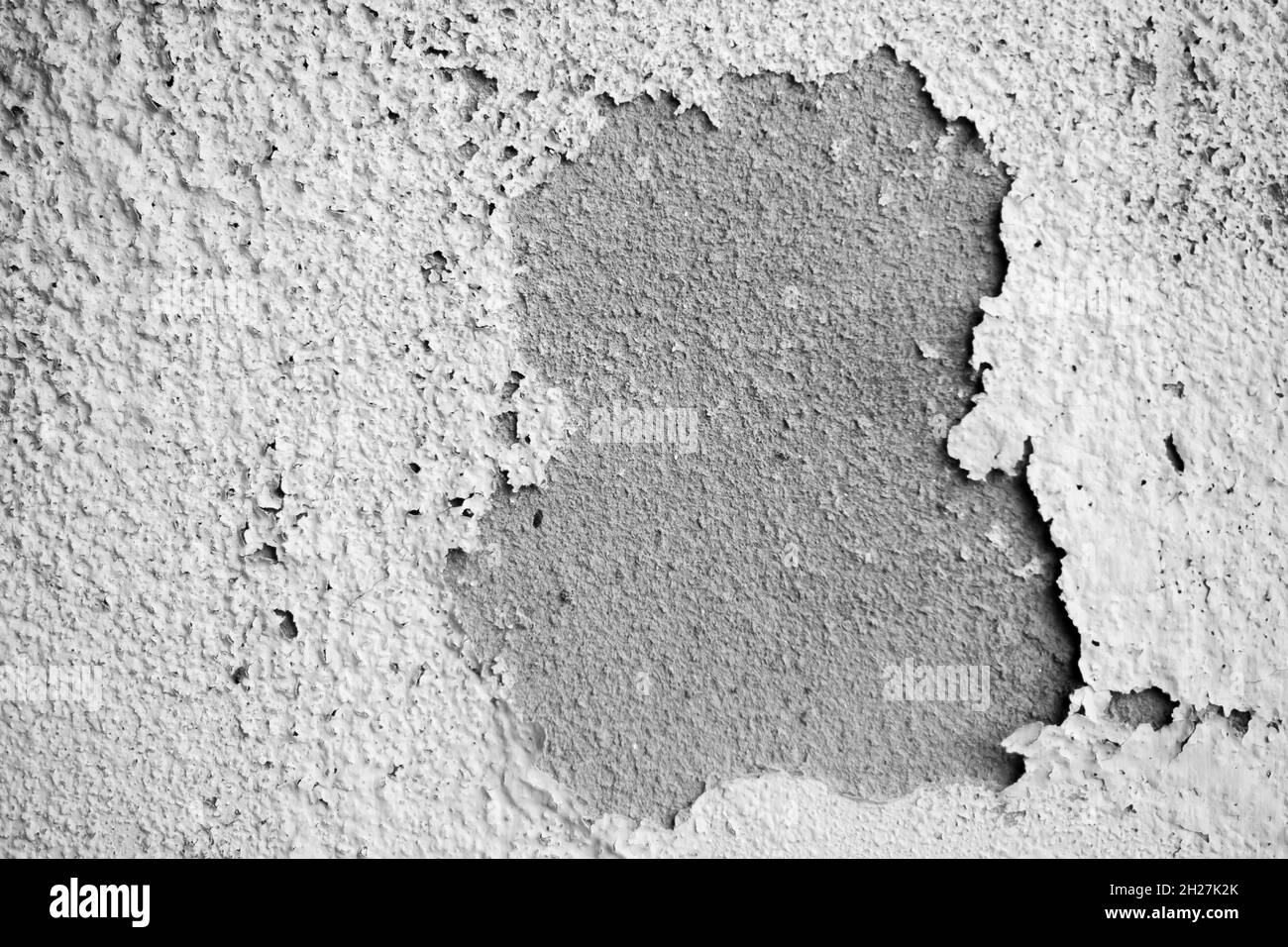 White damp wall showing paint cracking open and breaking or peeling off