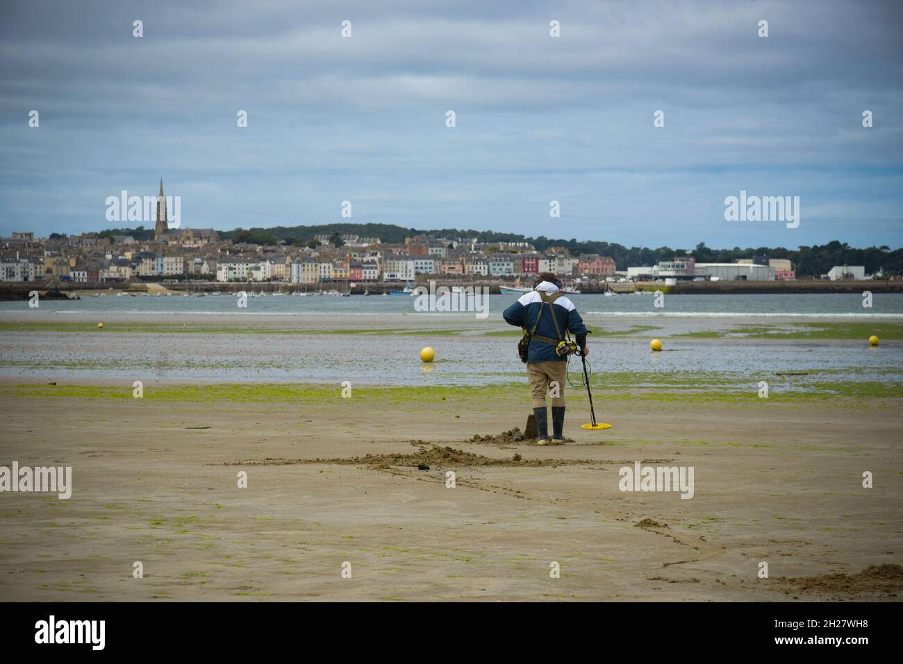 caucasian man using a metal detector on the beach on brittany Stock ...