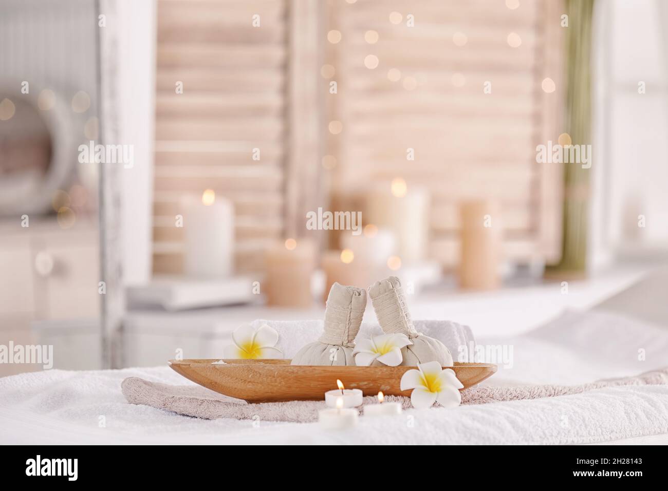 Supplies for massage on bed in modern spa salon. Place for relaxation