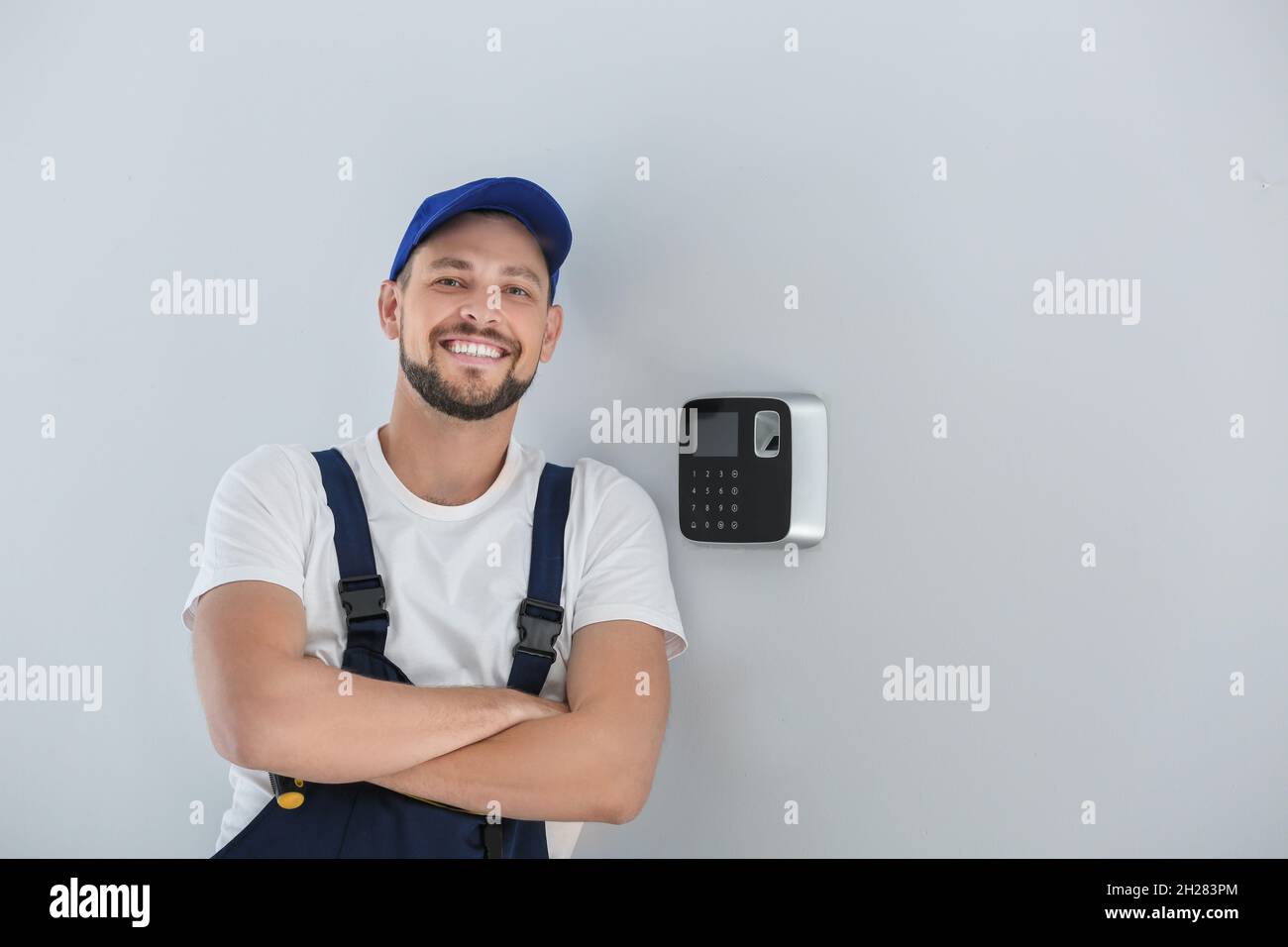 Male technician near installed alarm system indoors Stock Photo Alamy