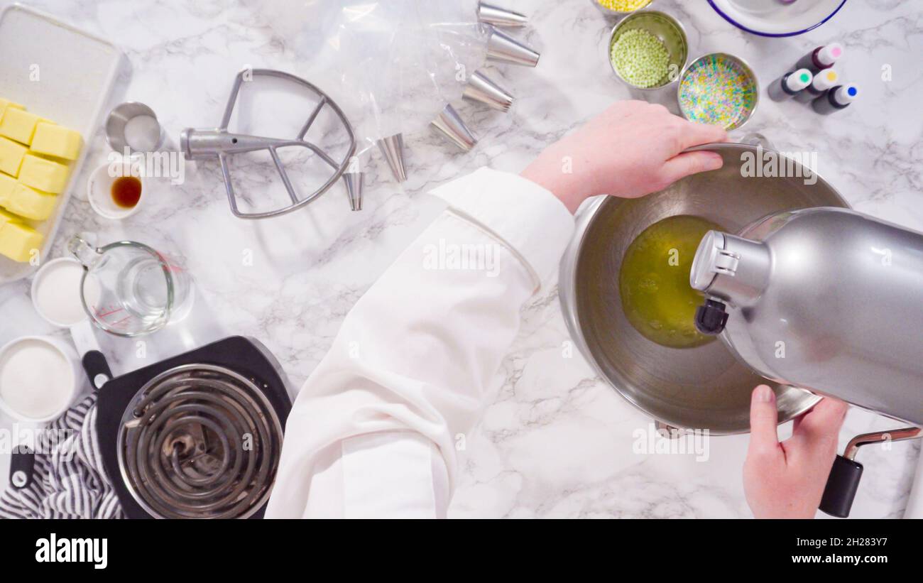 Preparing Italian buttercream frosting in standing kitchen mixer Stock