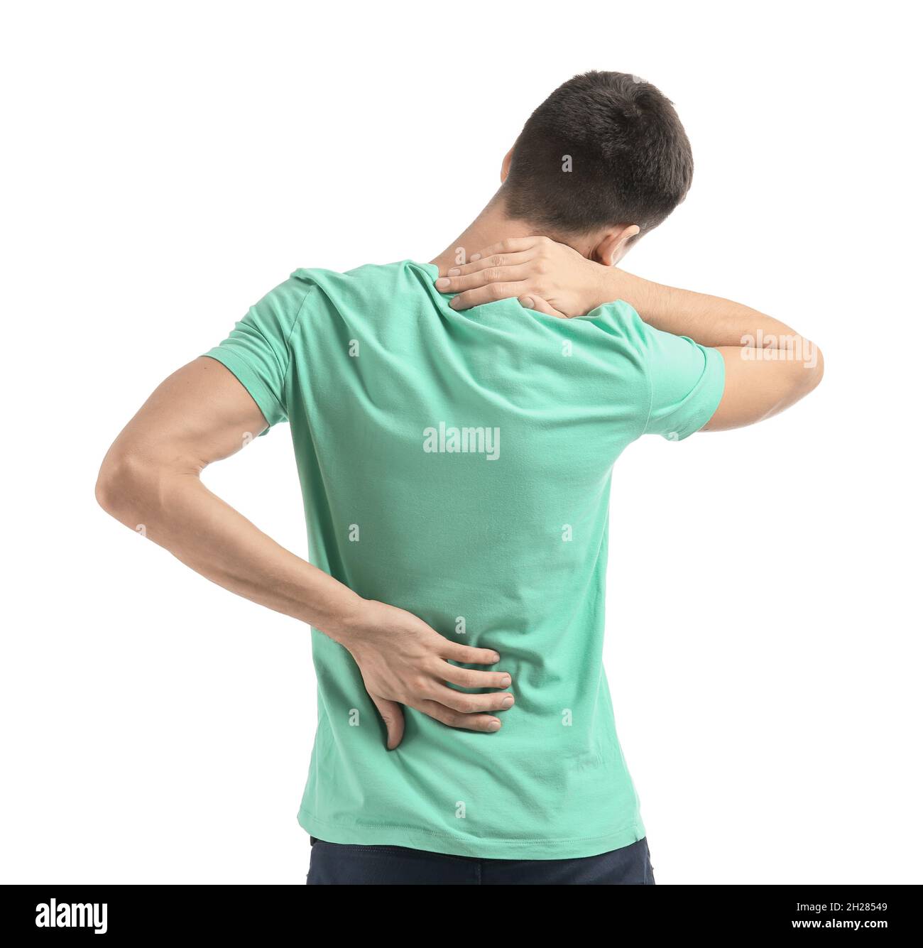 Young man suffering from back pain on white background Stock Photo - Alamy