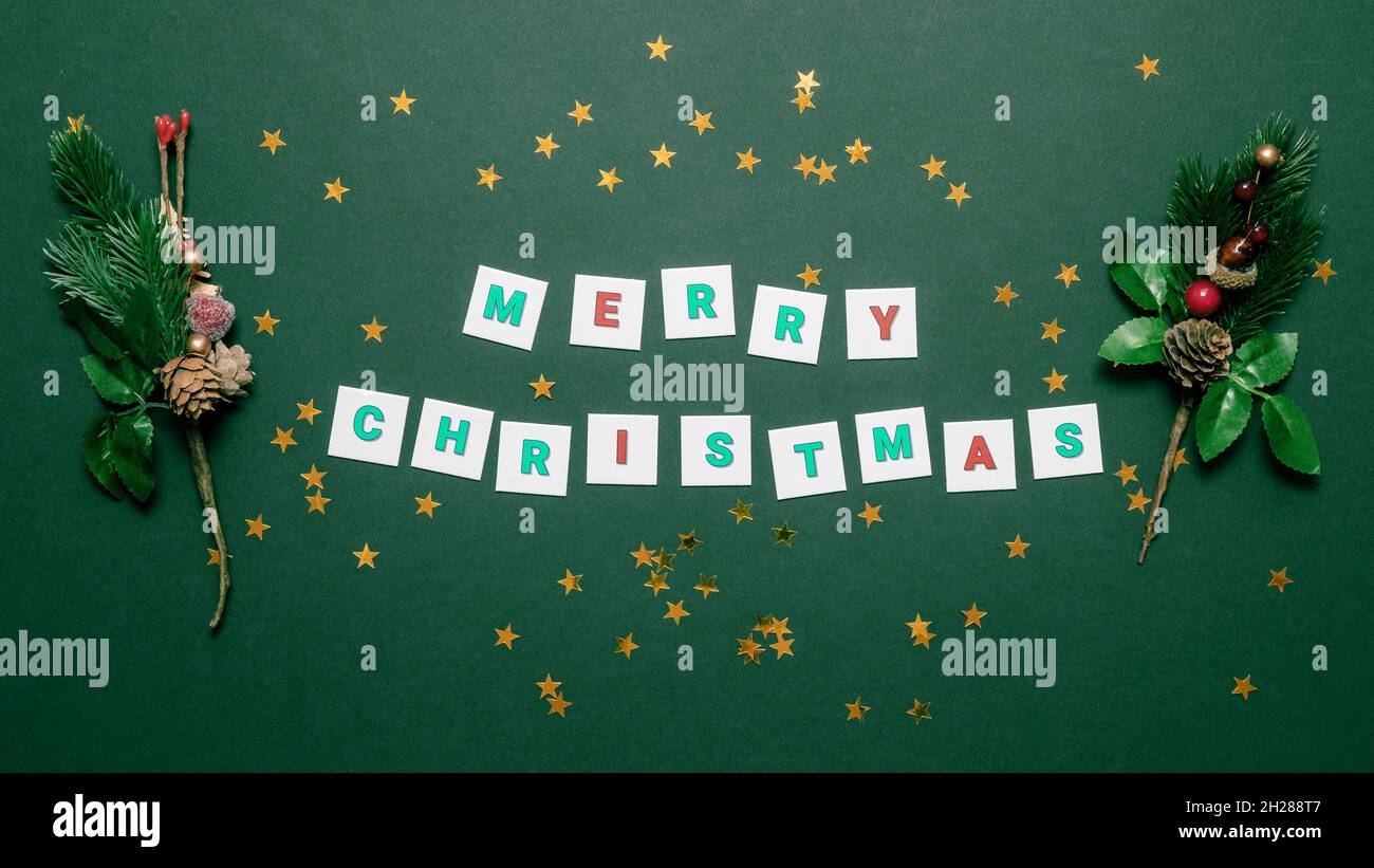 Merry christmas lettering with decorative spruce branches on the sides ...