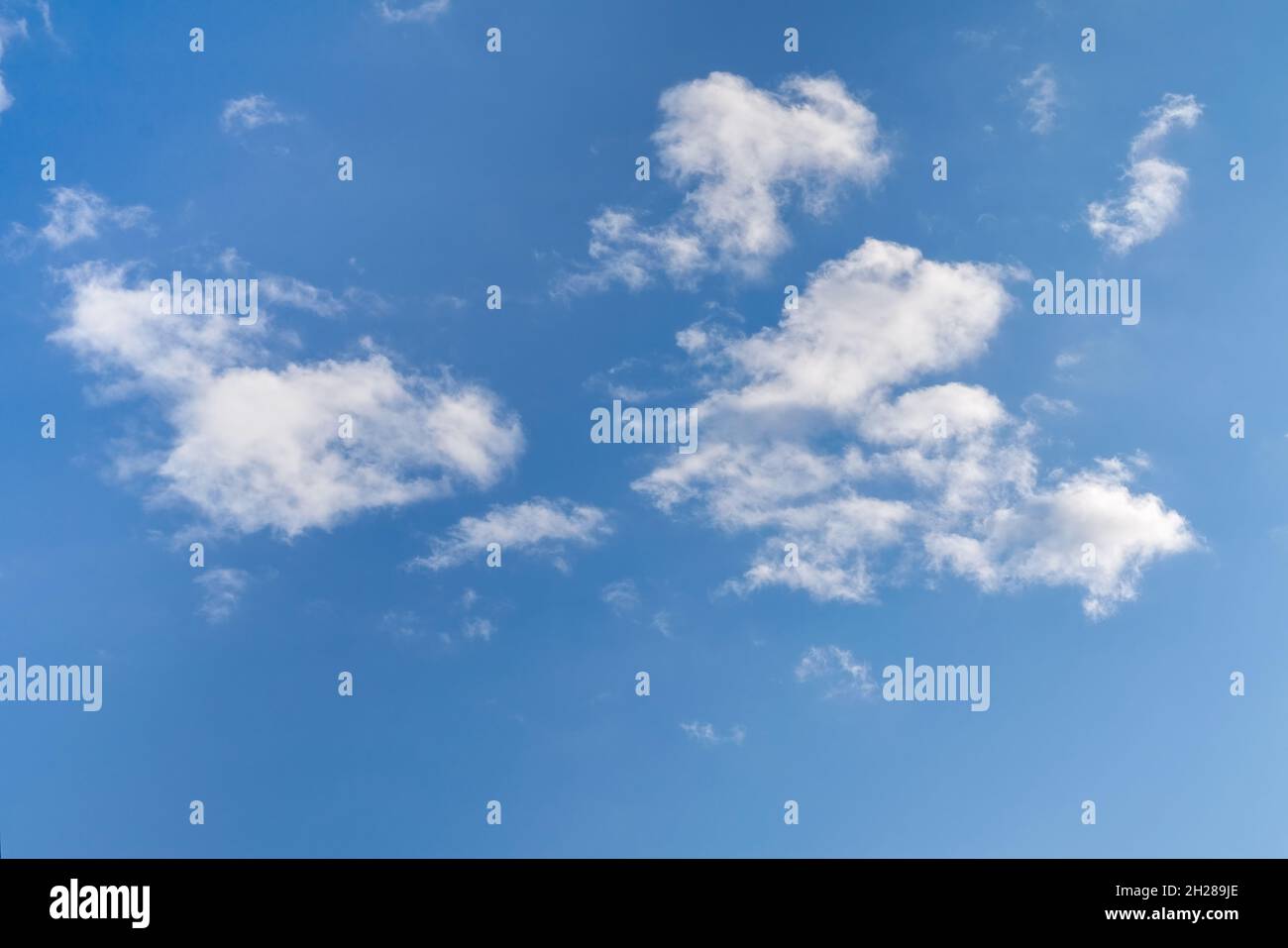 White fluffy clouds in the blue sky. Blue summer sky with white cumulus ...