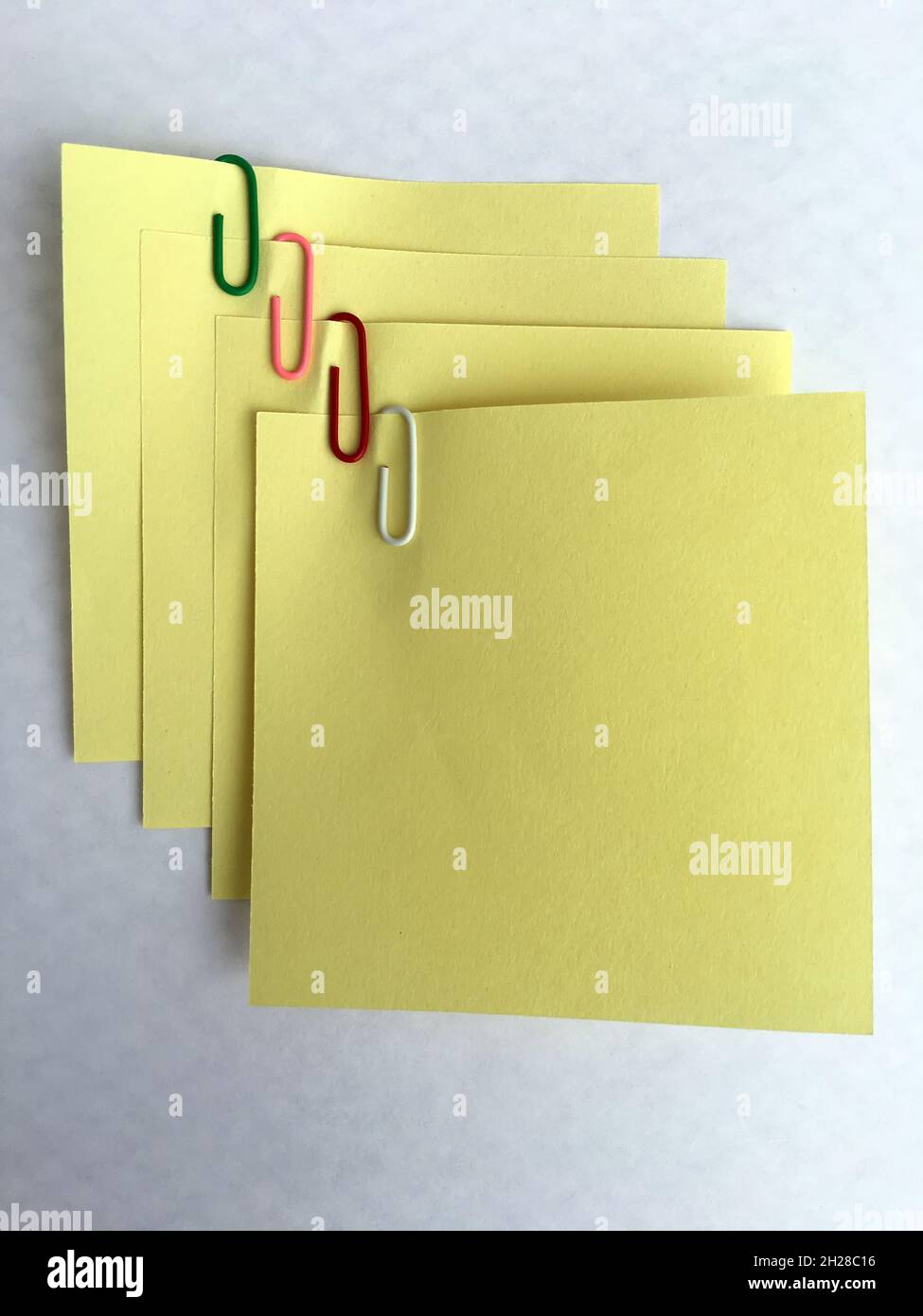 Yellow paper notes binden with staples. Notes and staples Stock Photo ...